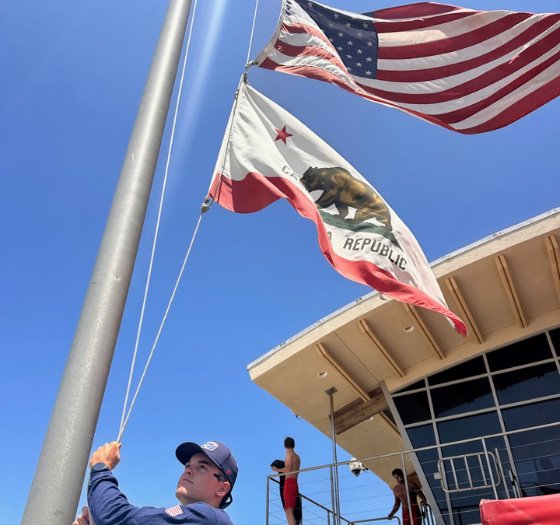 lifeguard raises flags