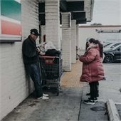 woman gathers information from man who appears to be homeless