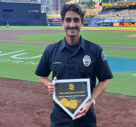 Lifeguard Aidan Goodman displays award