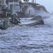 waves crash into seawall