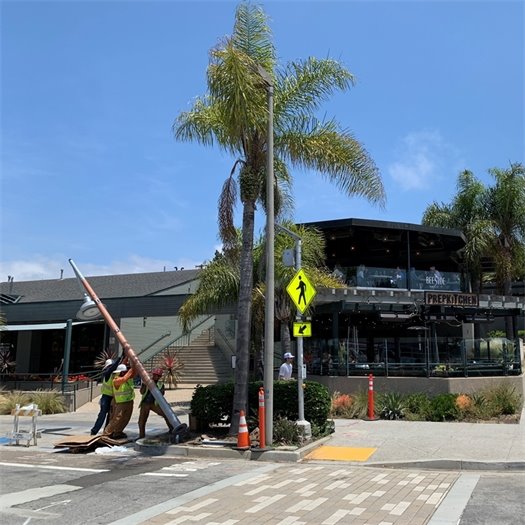 Workers install new streetlight at 12th Street