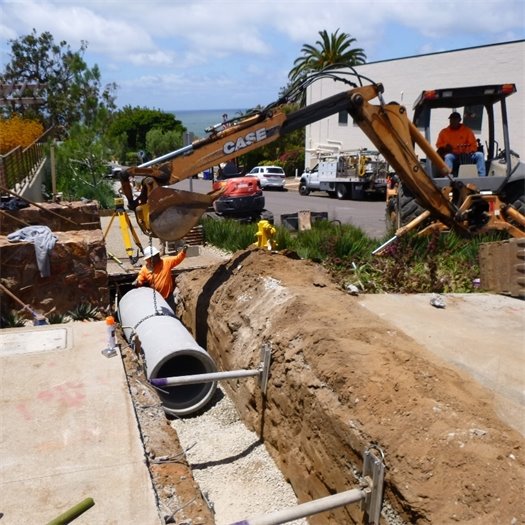 Workers replace a storm drain at 11th Street